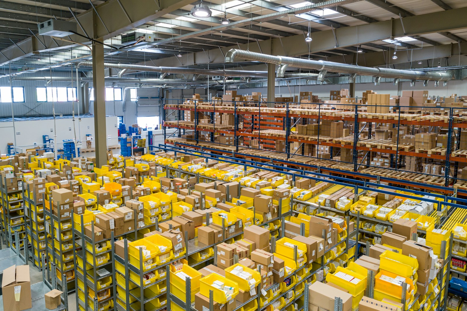 Organised warehouse with tall pallet racks and goods ready for distribution